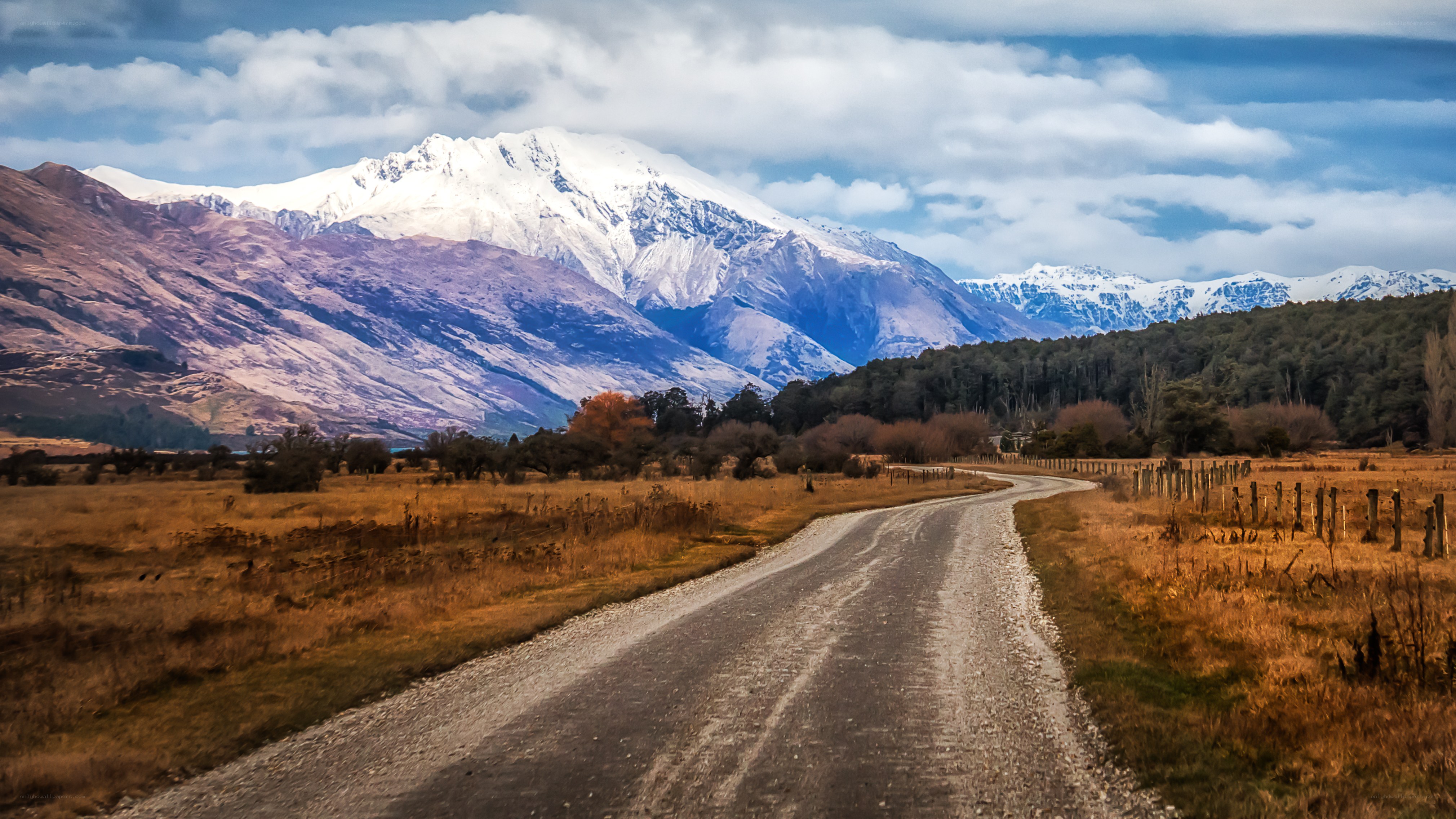 Gravel road to snow-capped mountains