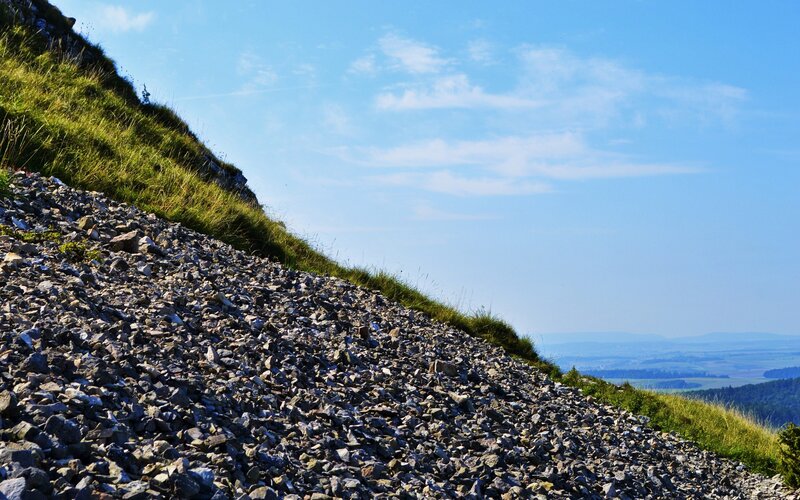 Gravel slope under blue sky