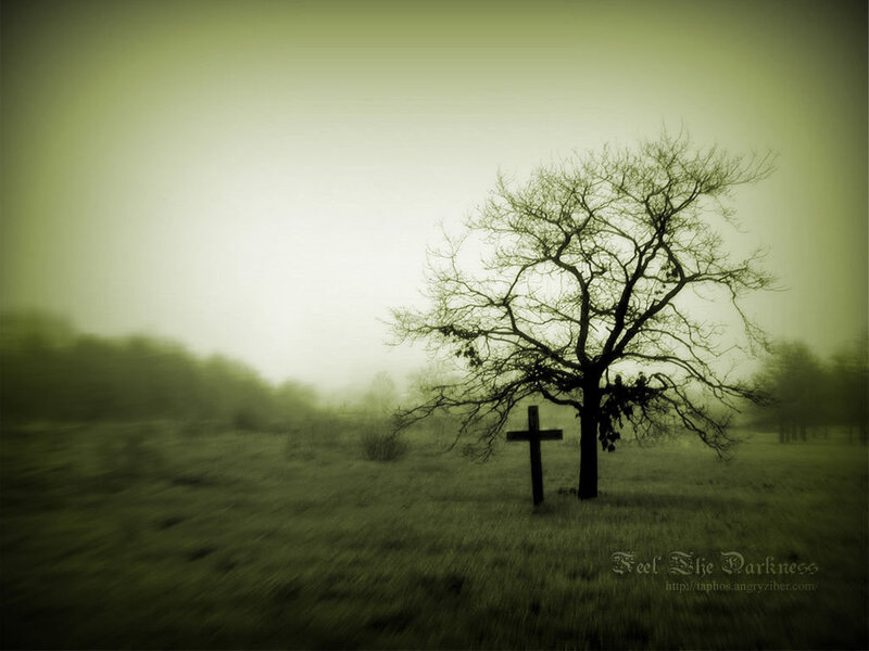 Graveyard cross in fog