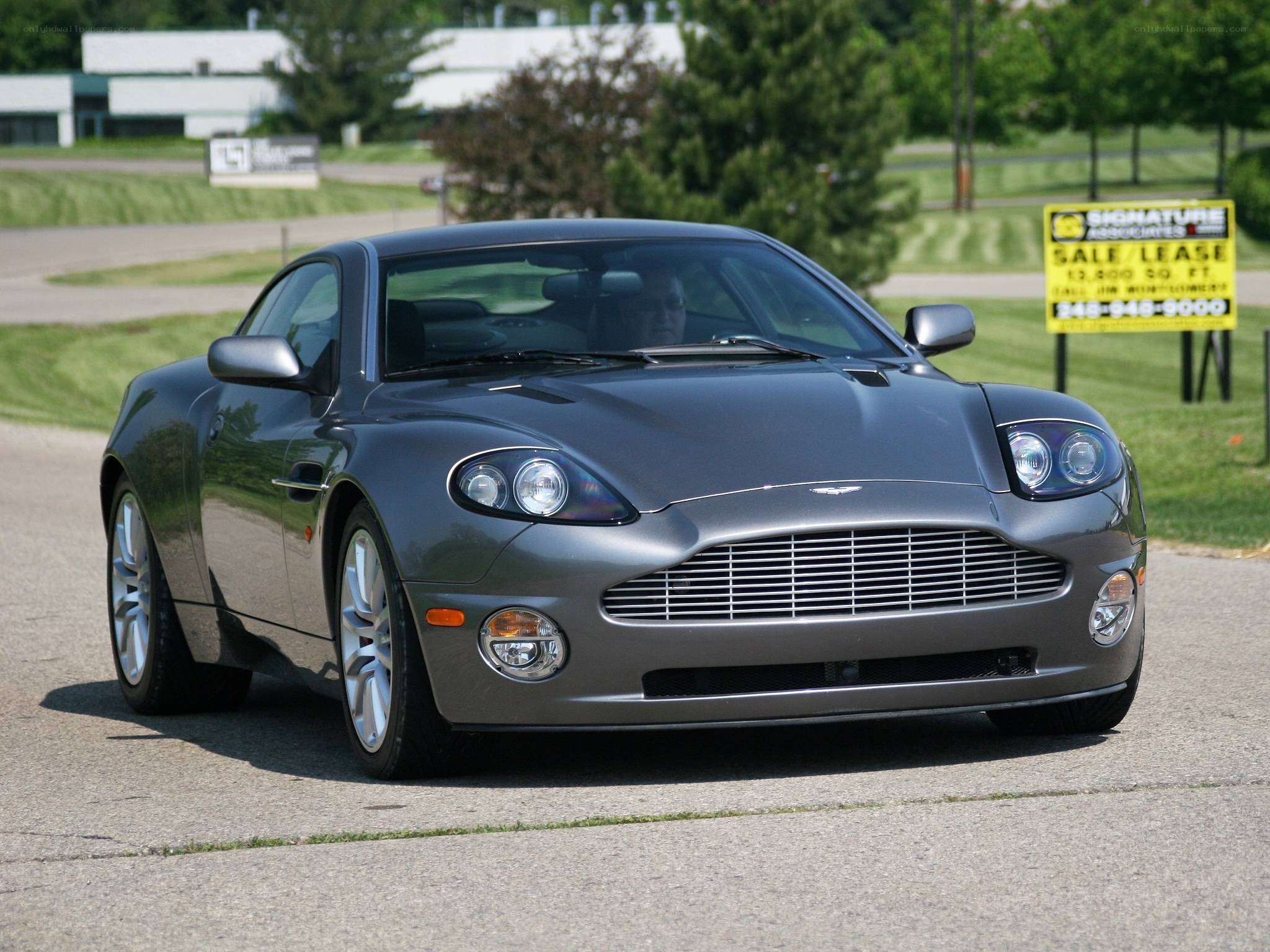 Gray Aston Martin on a road