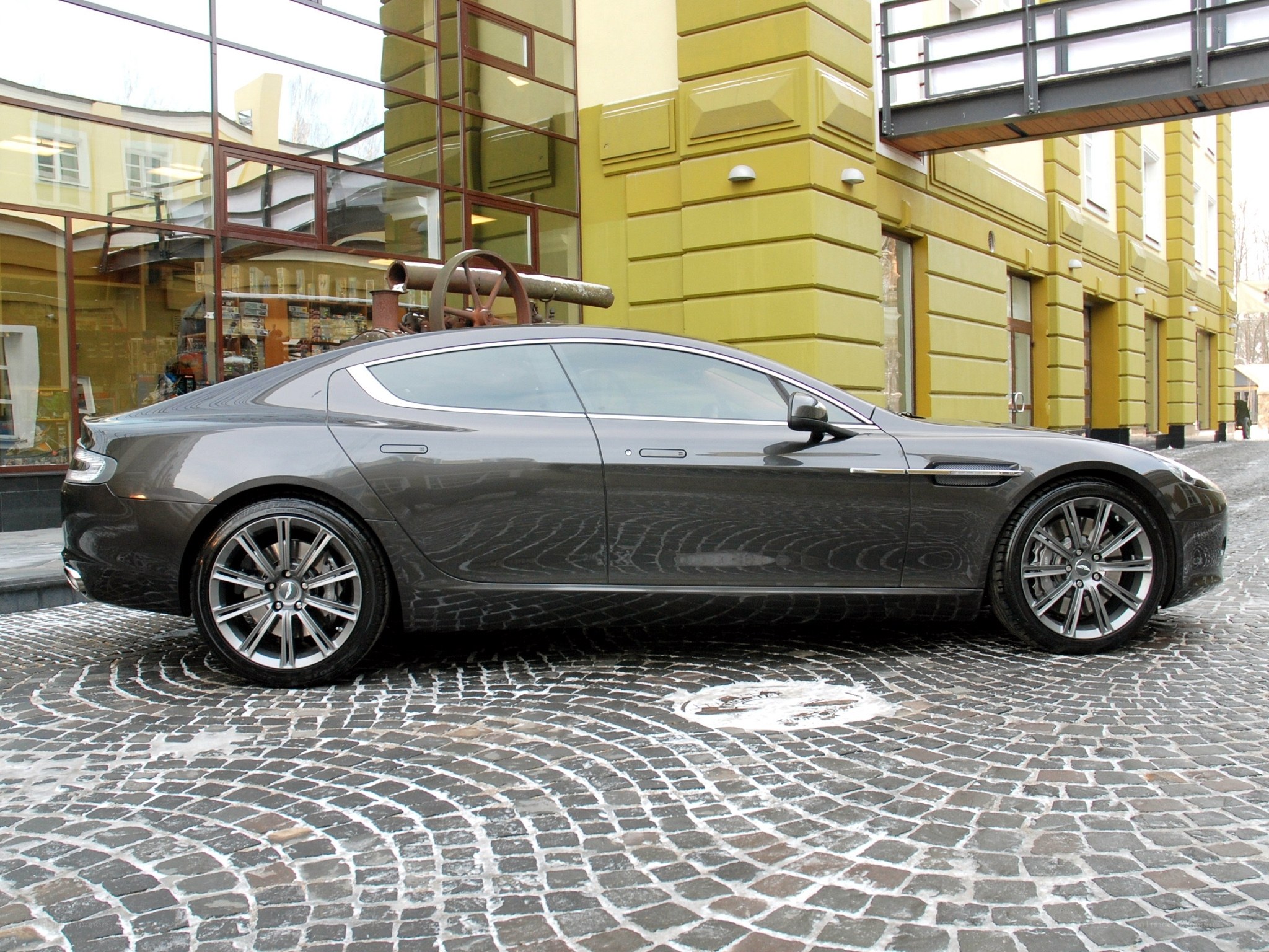 Gray Aston Martin on cobblestones