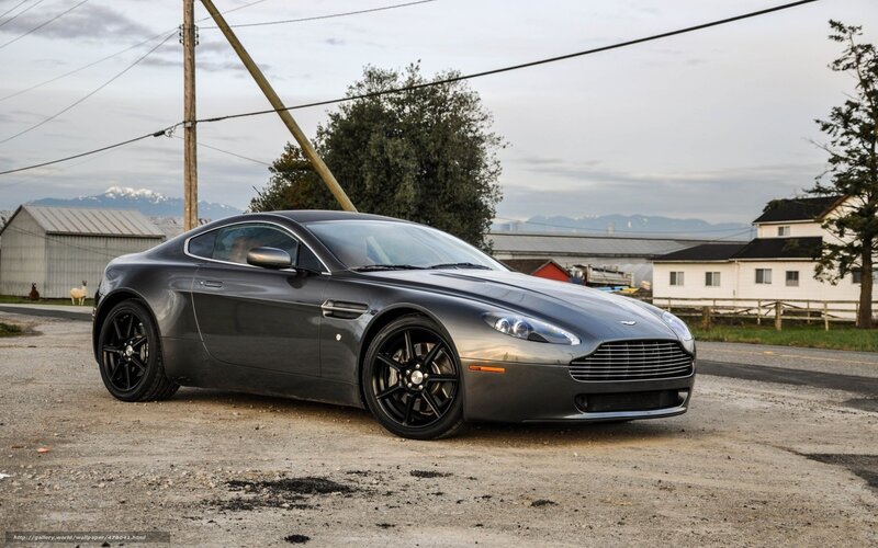 Gray Aston Martin on gravel