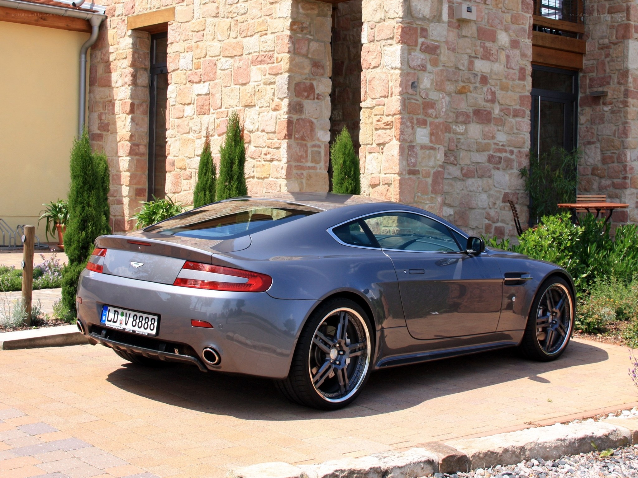 Gray Aston Martin parked outside