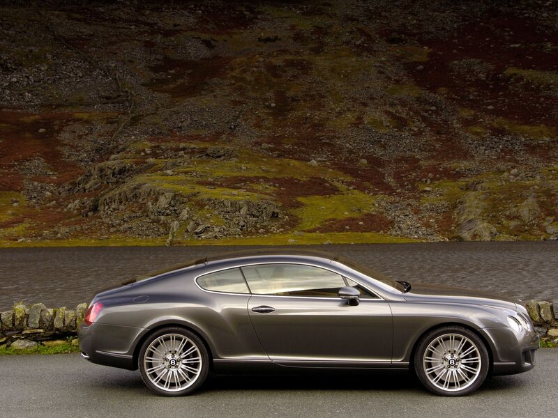 Gray Bentley parked by a lake