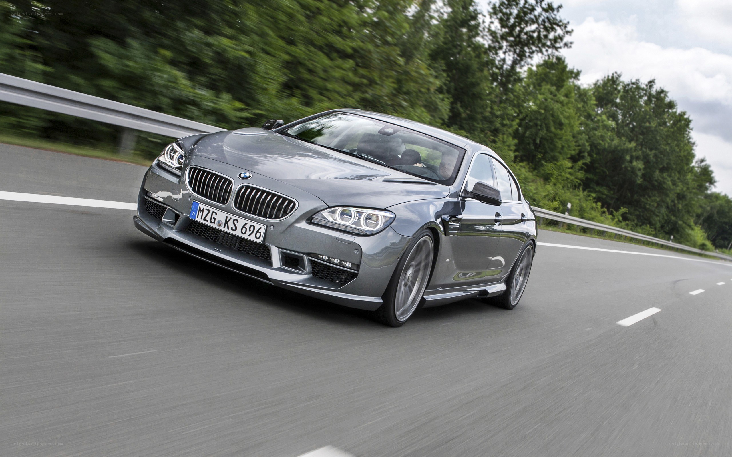 gray bmw driving on road
