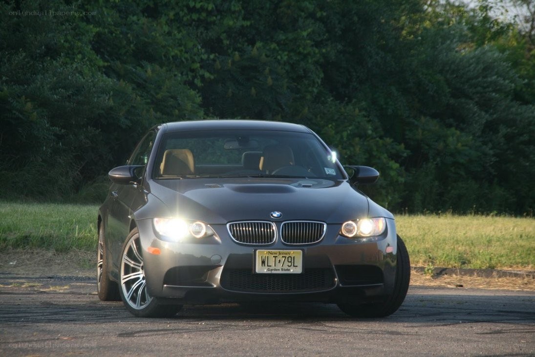 Gray BMW M3 with headlights on