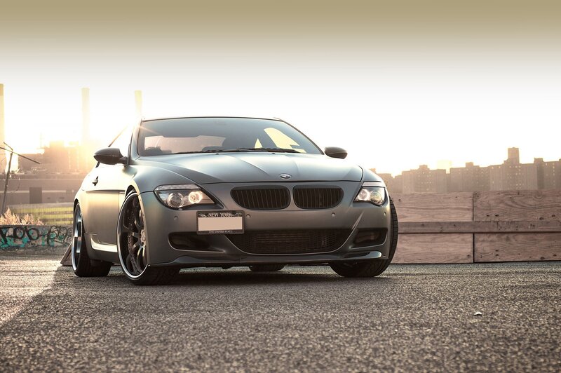 gray bmw on rooftop at sunset