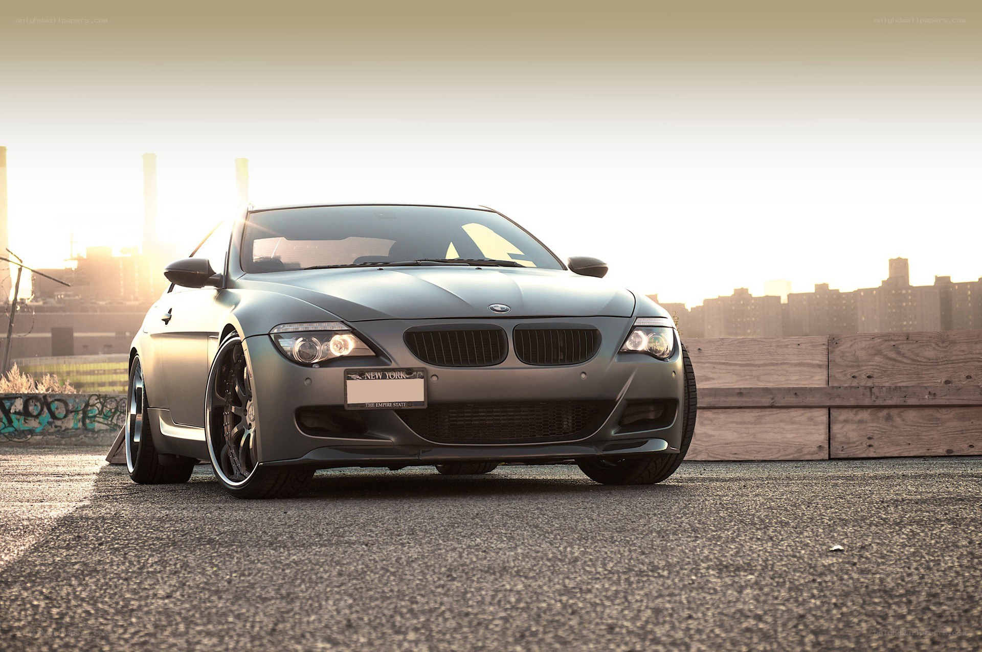 gray bmw on rooftop at sunset