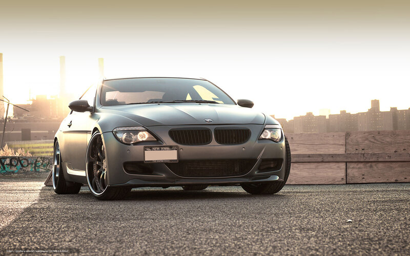gray bmw on rooftop at sunset