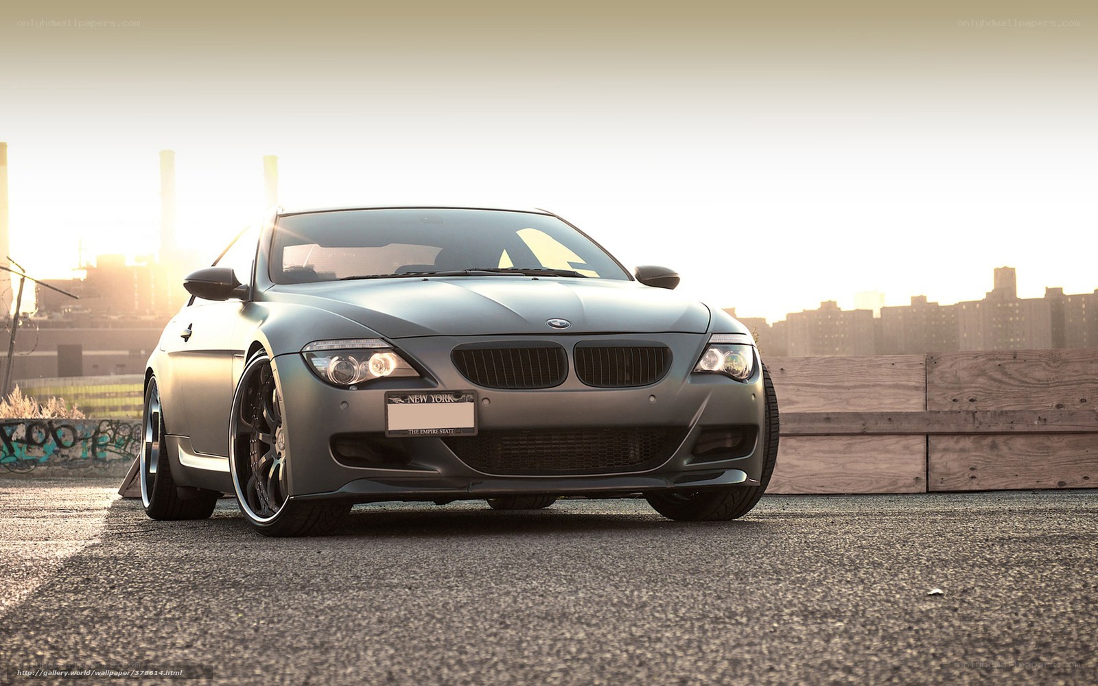 gray bmw on rooftop at sunset