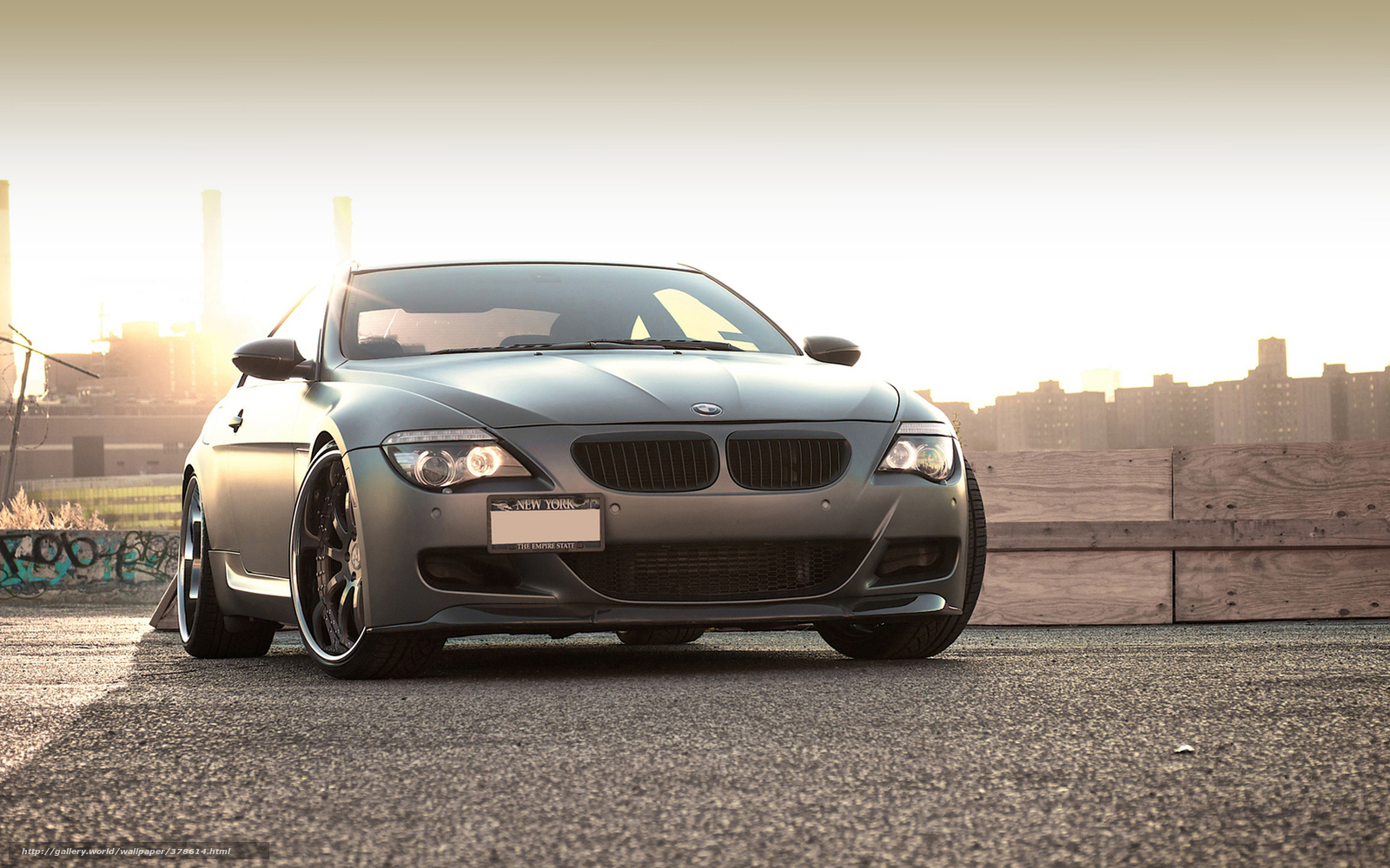 gray bmw on rooftop at sunset