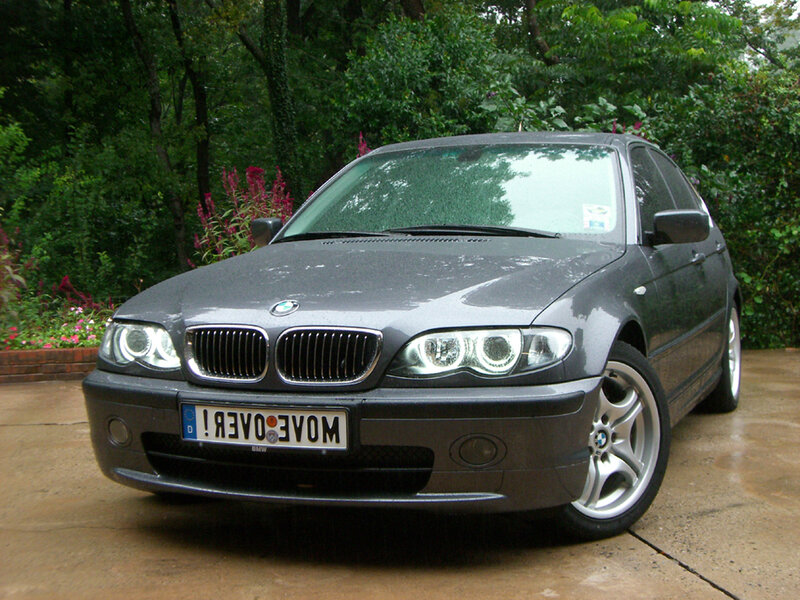 gray bmw parked in garden