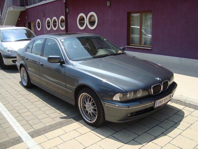 Gray BMW parked on pavement