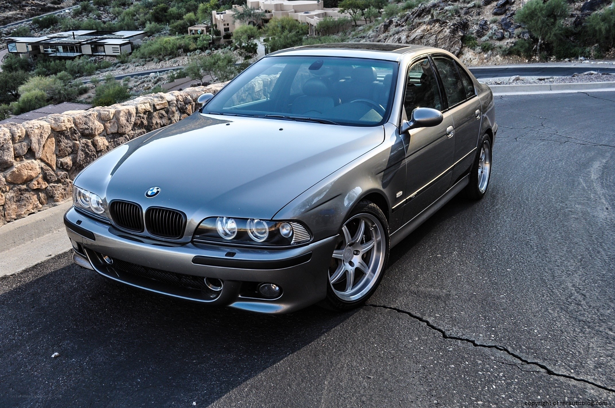 Gray BMW sedan on a road