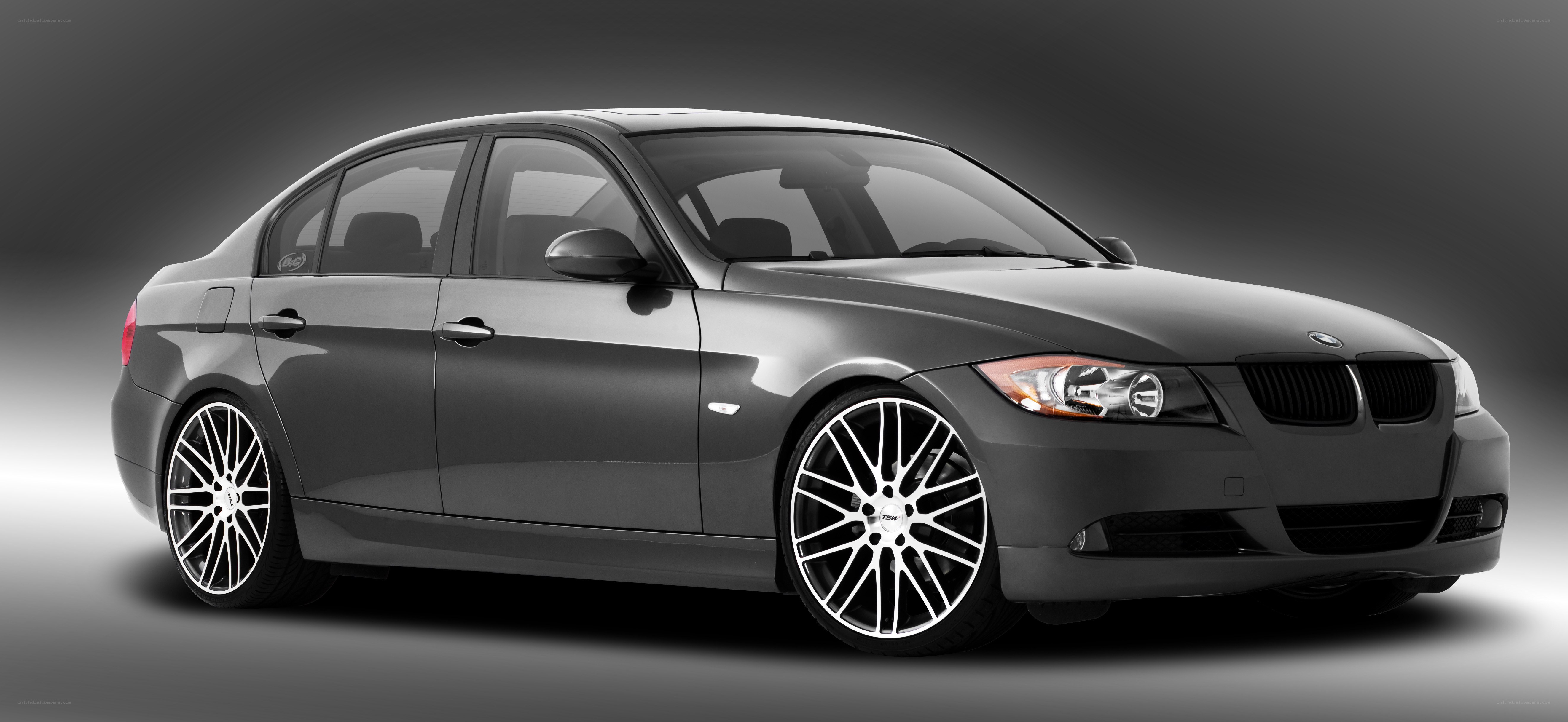 gray bmw sedan with custom wheels