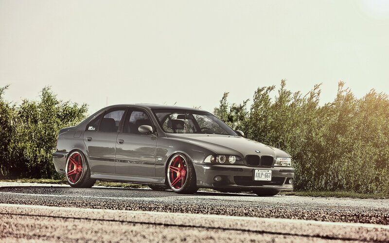 gray bmw sedan with red wheels