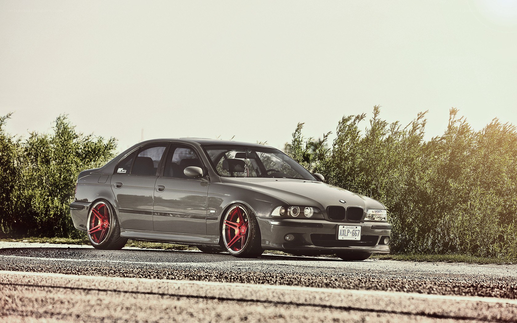 gray bmw sedan with red wheels