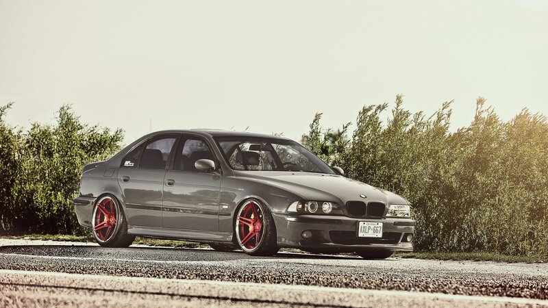 gray bmw sedan with red wheels