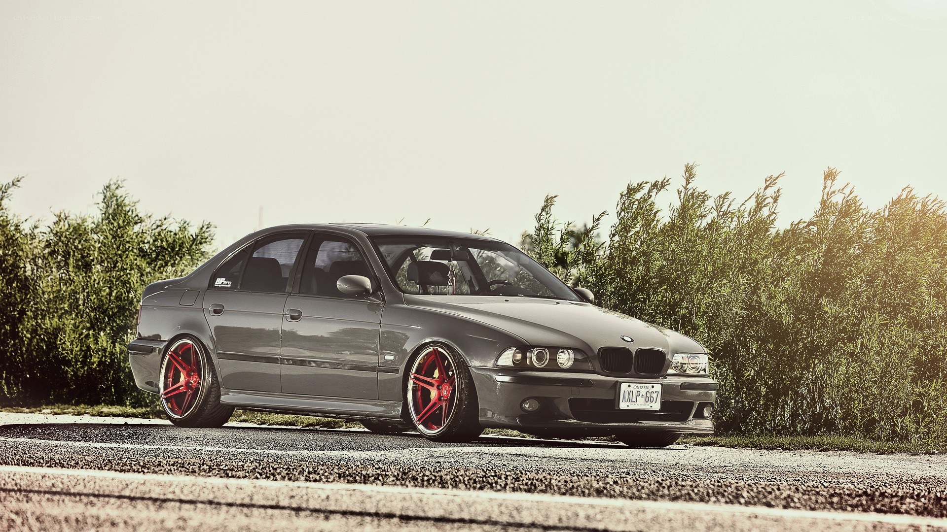 gray bmw sedan with red wheels