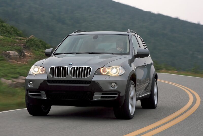 Gray BMW SUV on a winding road