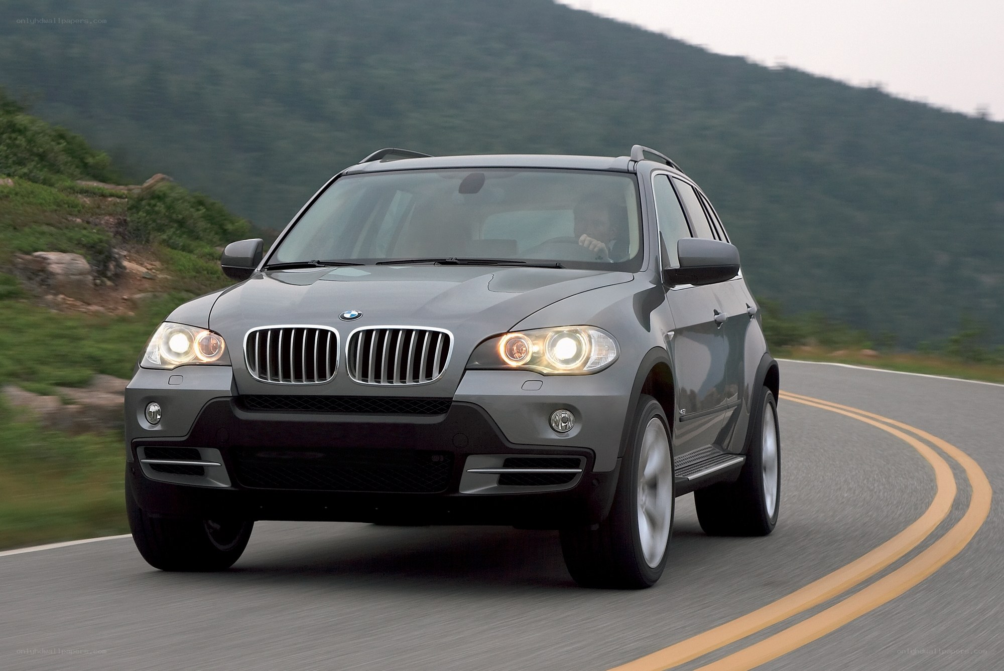 Gray BMW SUV on a winding road