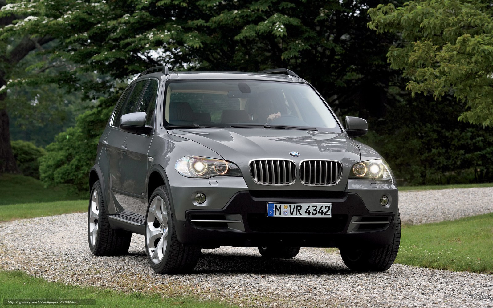 Gray BMW X5 on gravel path