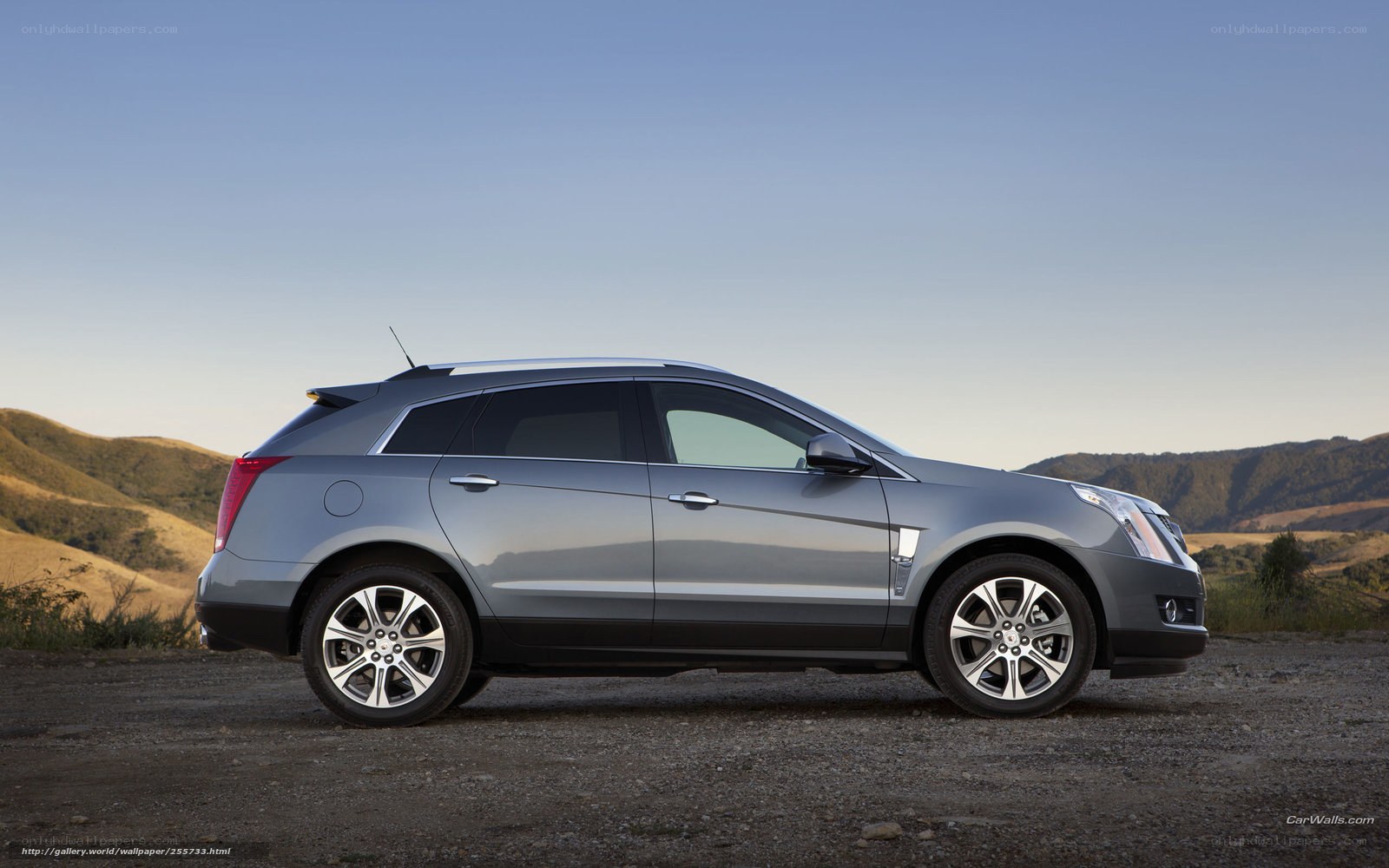 gray cadillac suv on dirt road