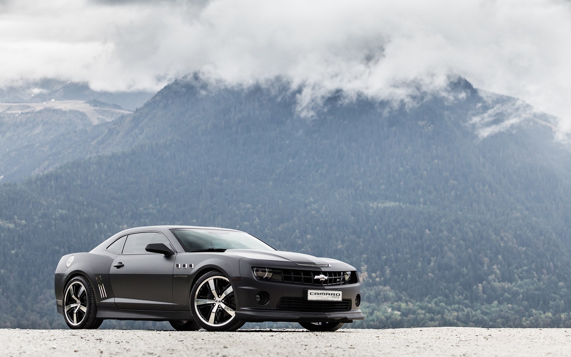 Gray Camaro in mountain landscape