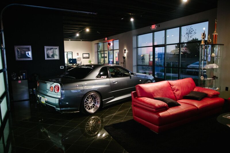 Gray car and red sofa in showroom