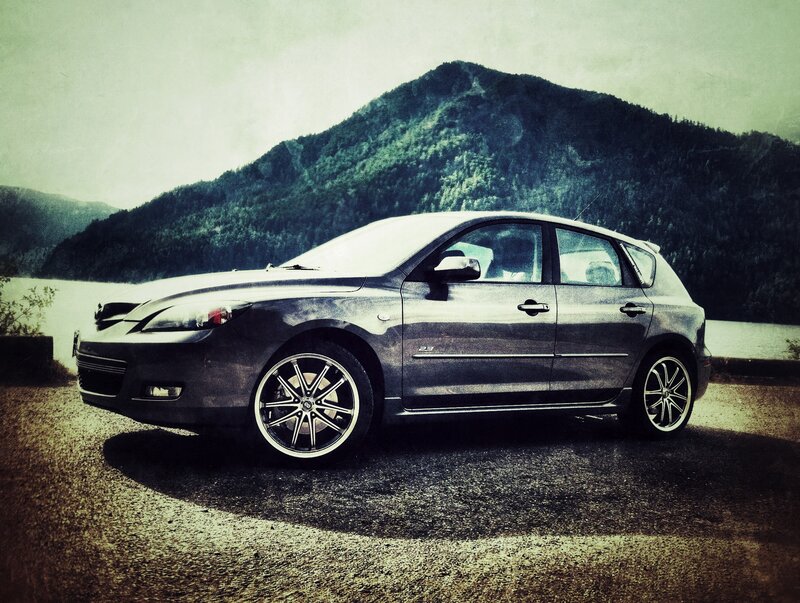 Gray car by a lake