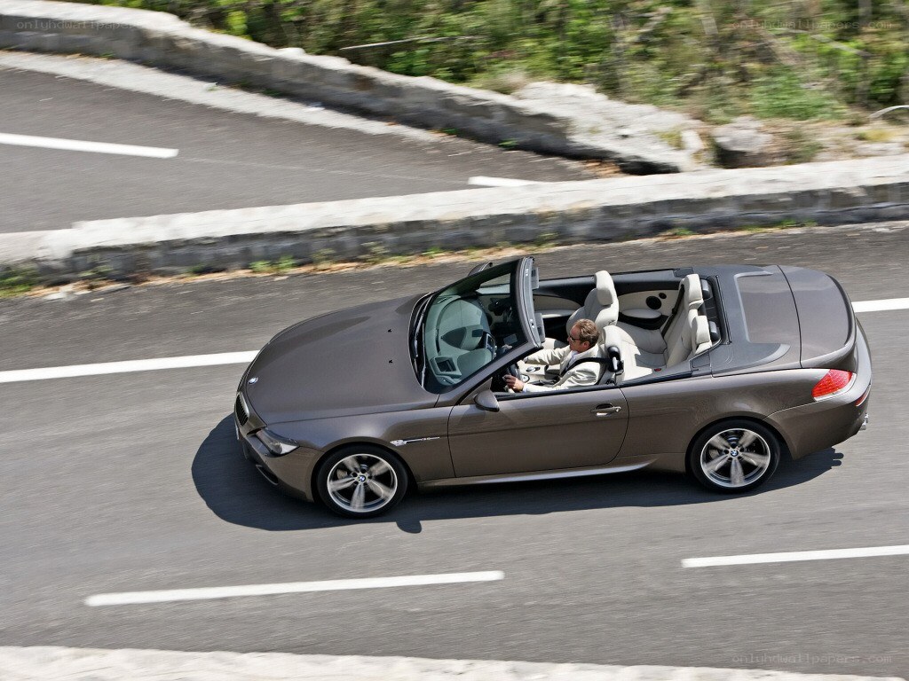 gray convertible driving on road