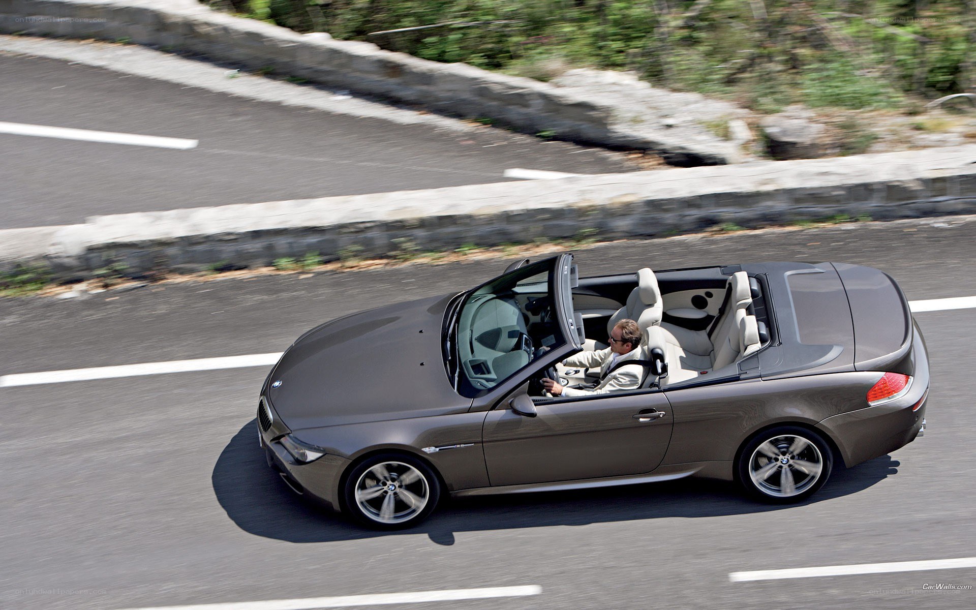 gray convertible driving on road