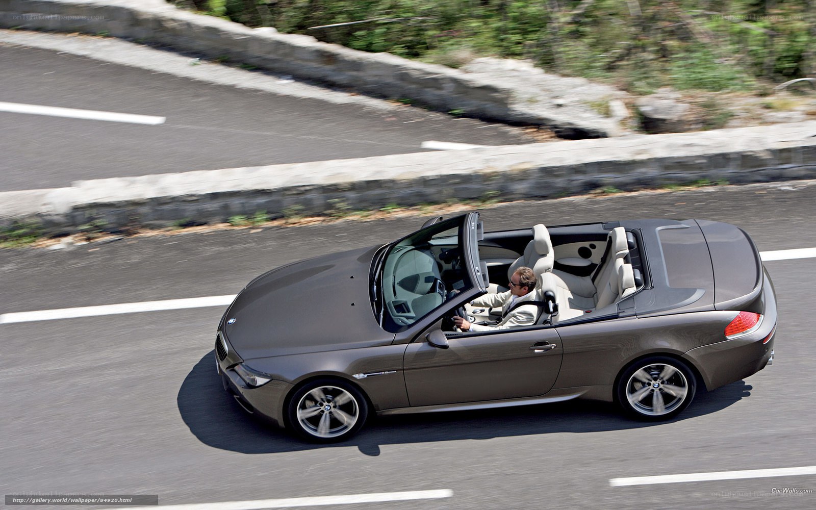 gray convertible driving on road