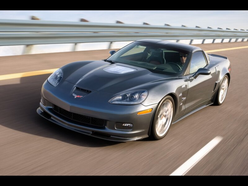 gray corvette driving on bridge