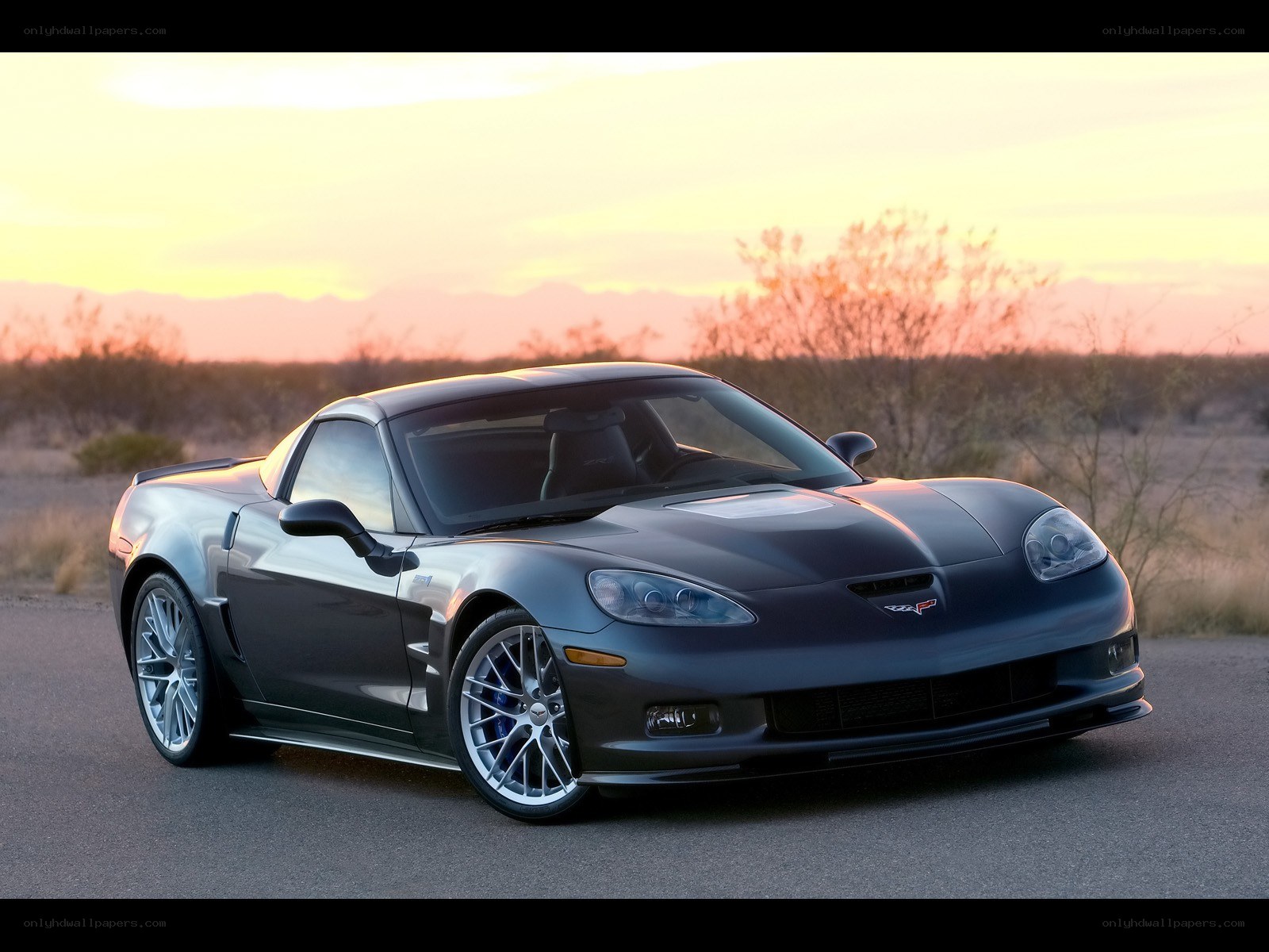 Gray Corvette in desert sunset