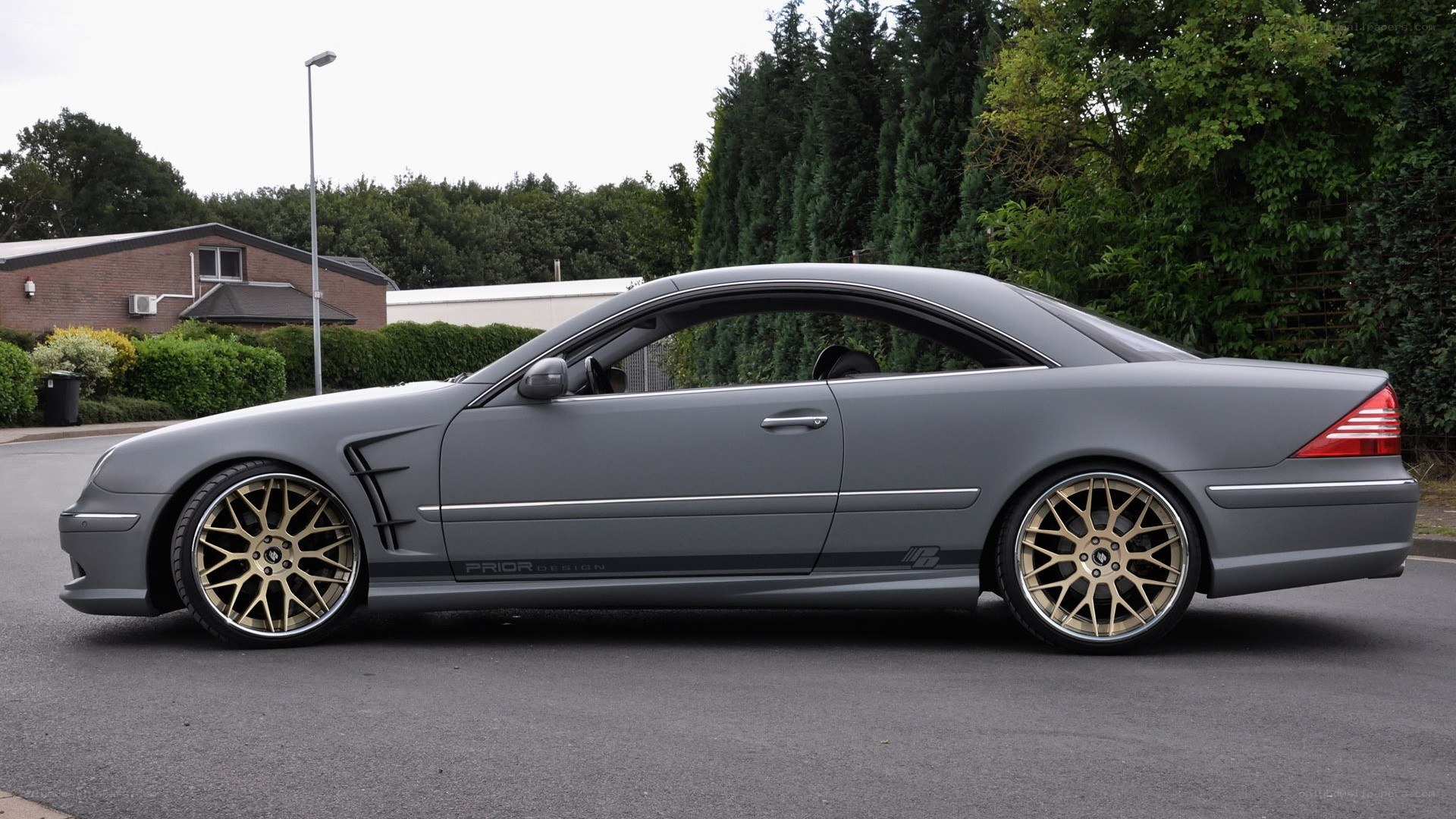 gray coupe with gold wheels