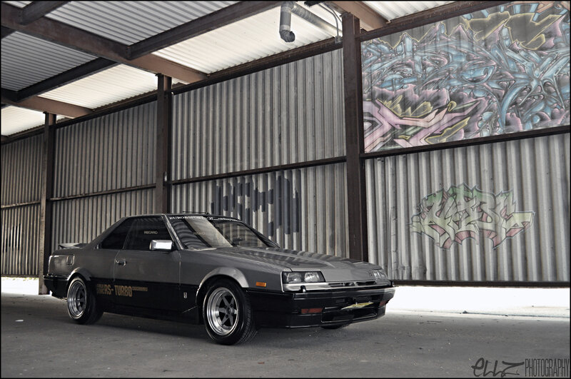 gray coupe with graffiti background