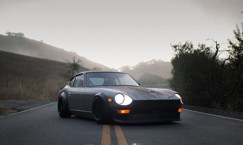 gray datsun on a winding road