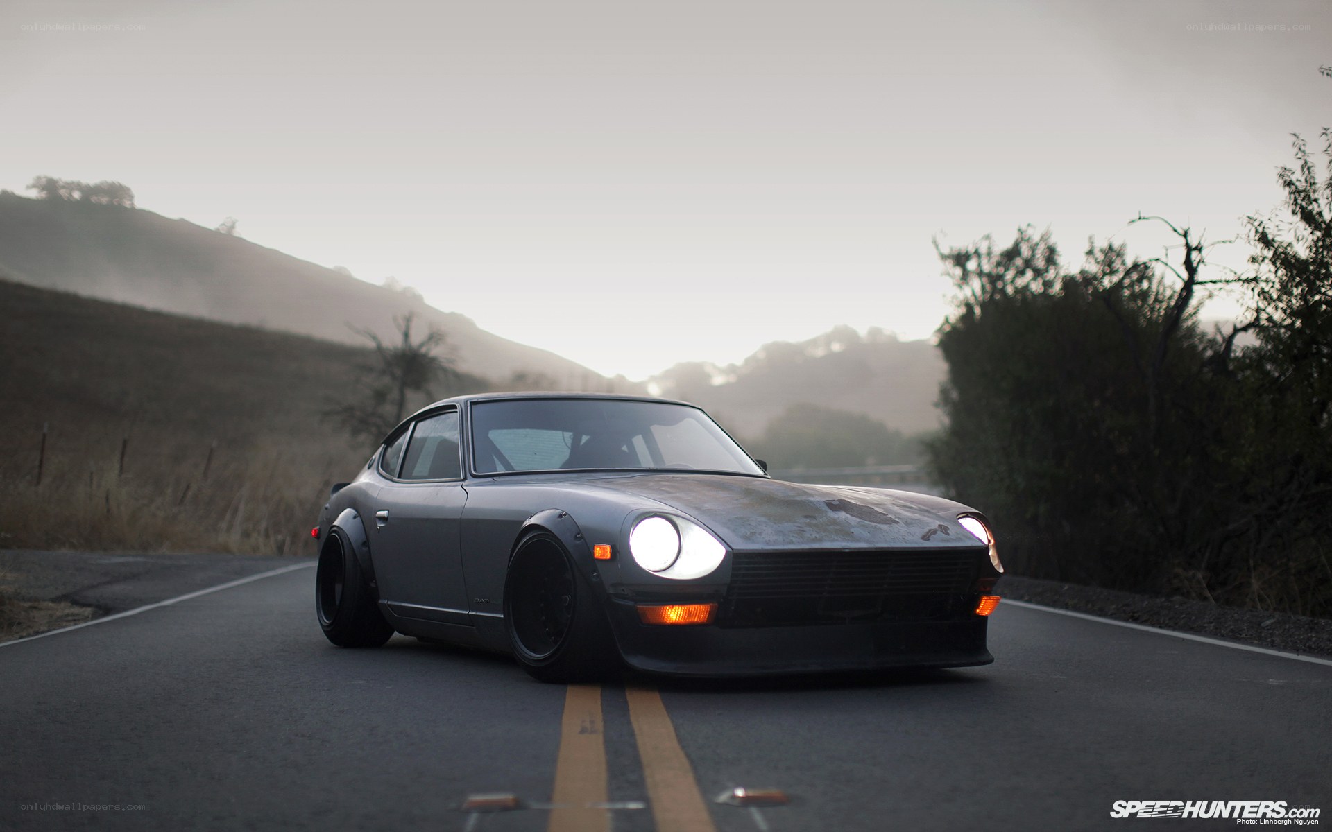 gray datsun on country road