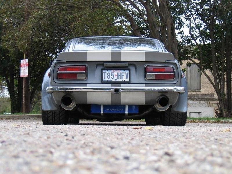 gray datsun with racing stripes