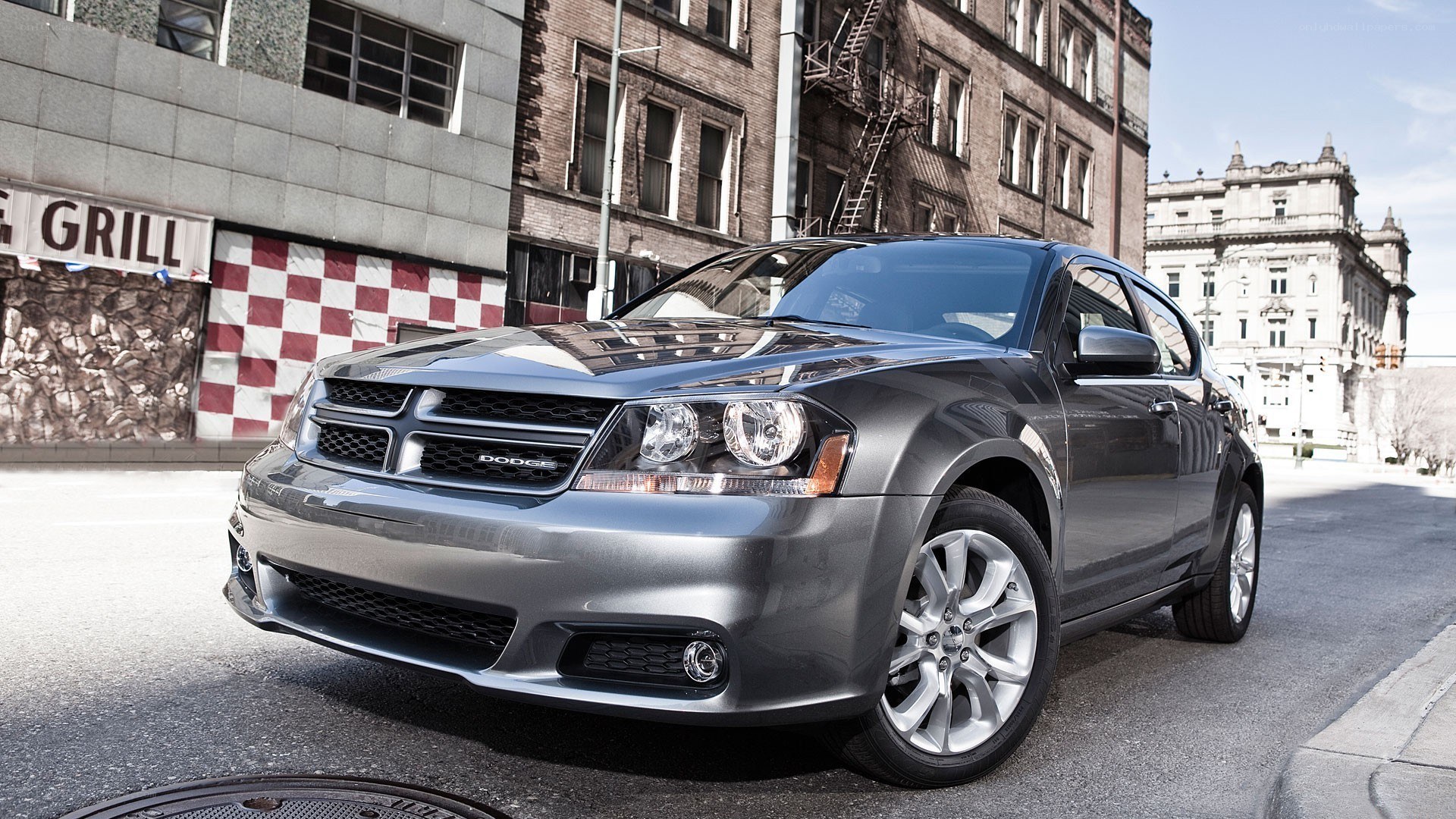 Gray Dodge Avenger on city street