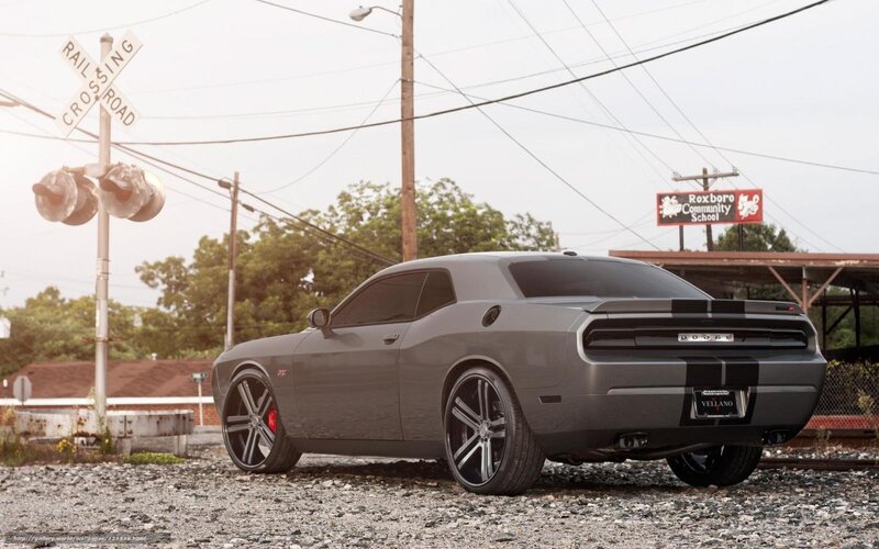 Gray Dodge Challenger at railroad crossing