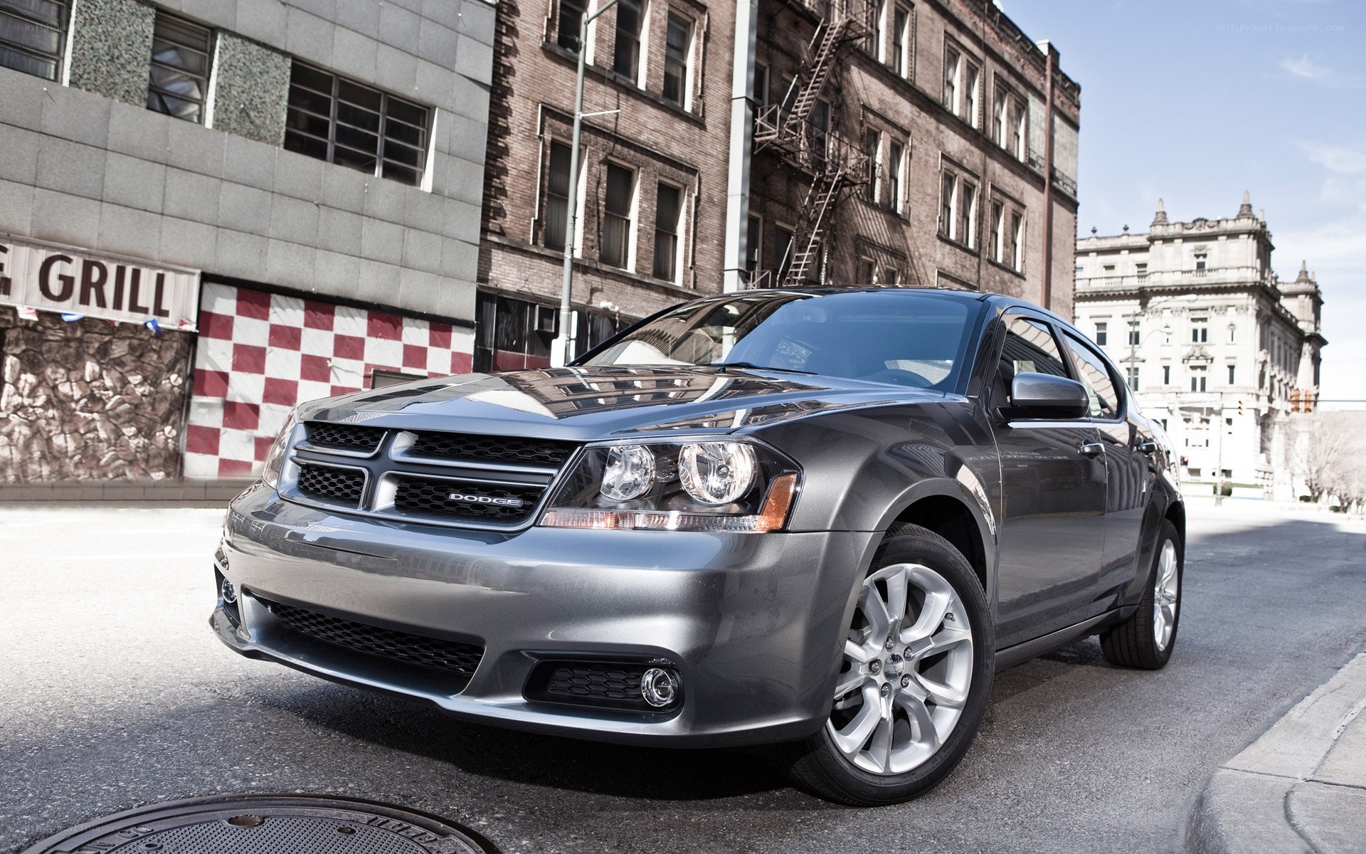 Gray Dodge sedan on city street