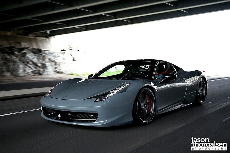 gray ferrari driving under bridge