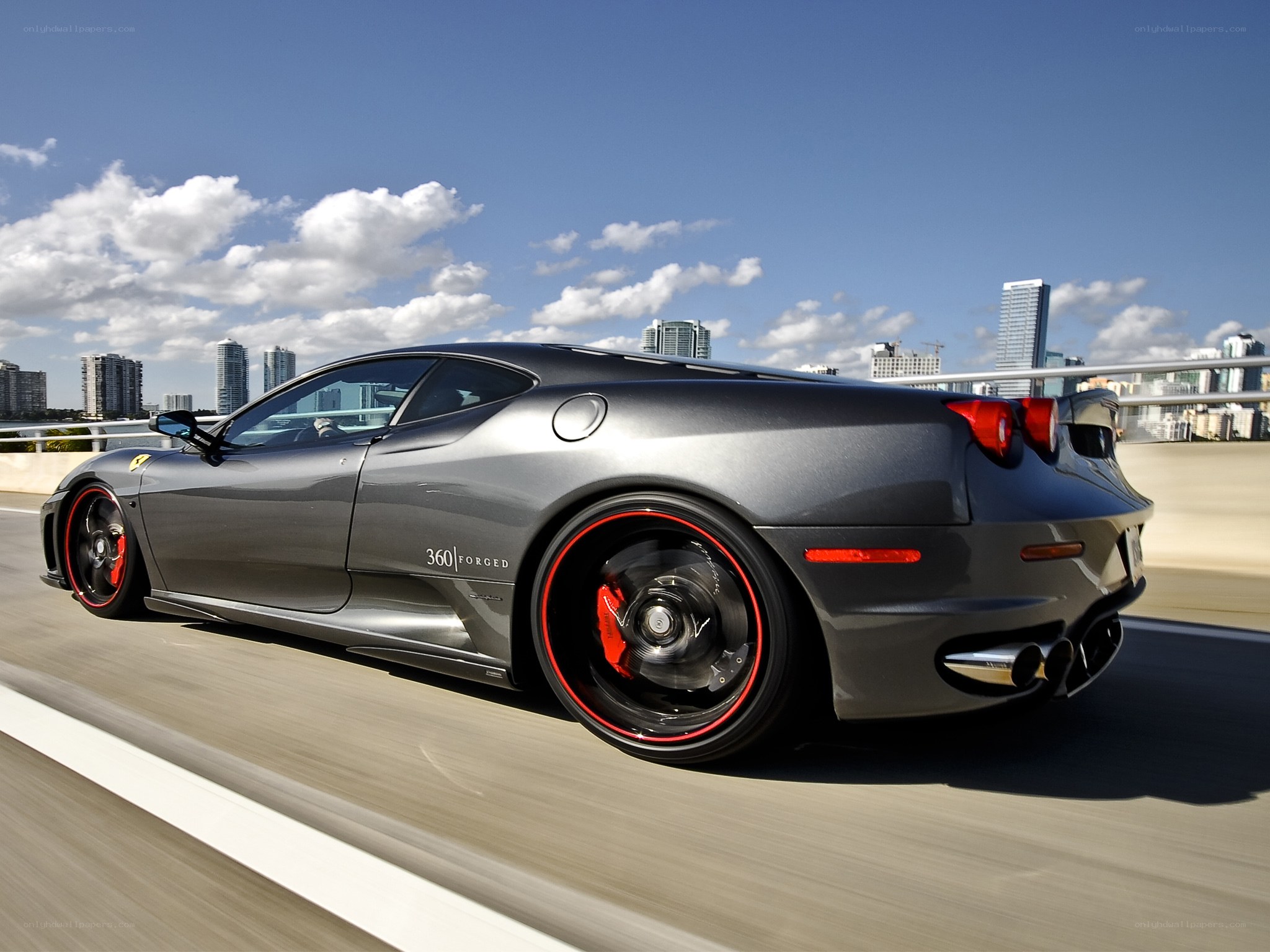 Gray Ferrari on a city bridge