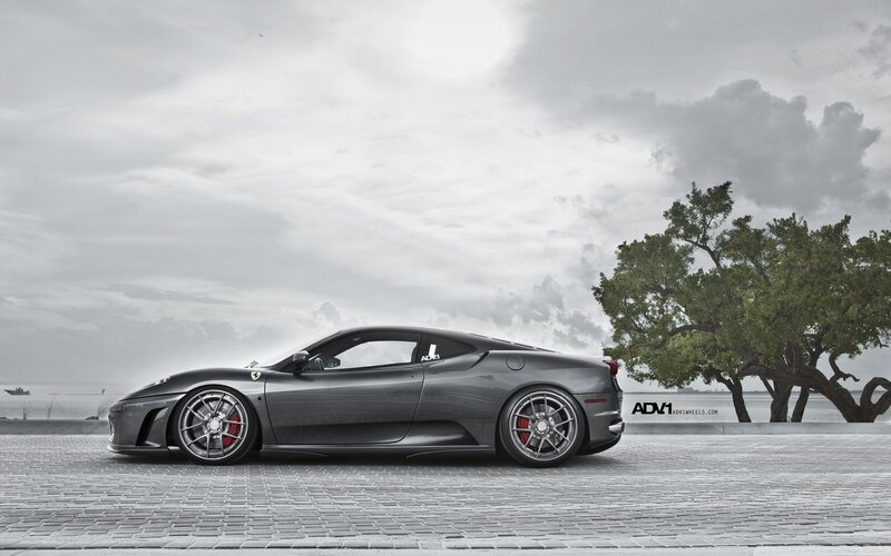 Gray Ferrari on a cobblestone pier