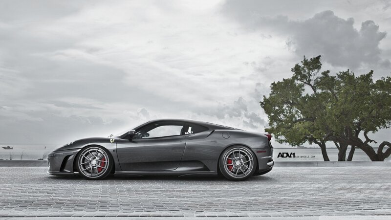 Gray Ferrari on a cobblestone pier