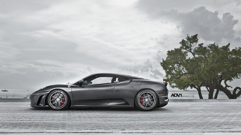 Gray Ferrari on a cobblestone street