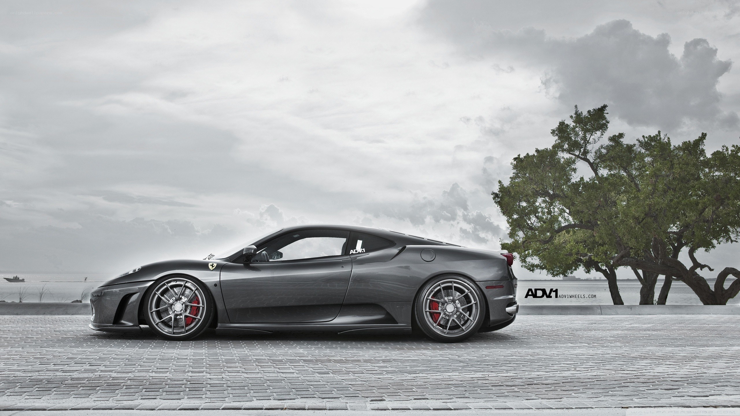 Gray Ferrari on a cobblestone street