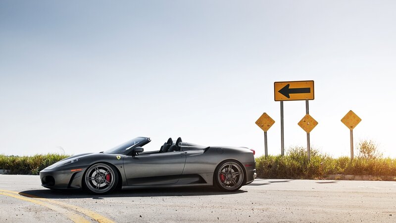 Gray Ferrari on a sunny road